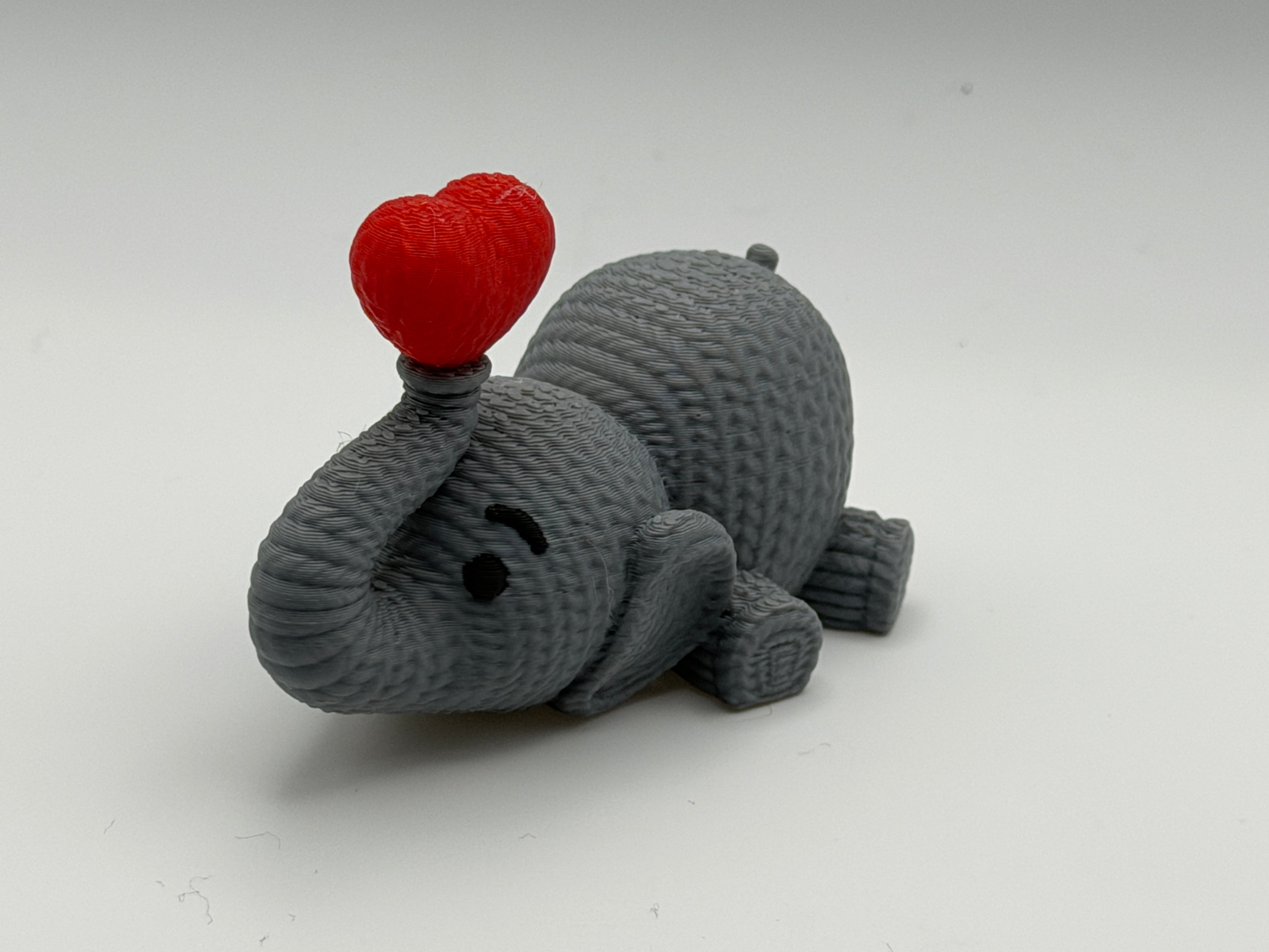 Cute Knitted effect Valentines Elephant lying down with heart on end of trunk