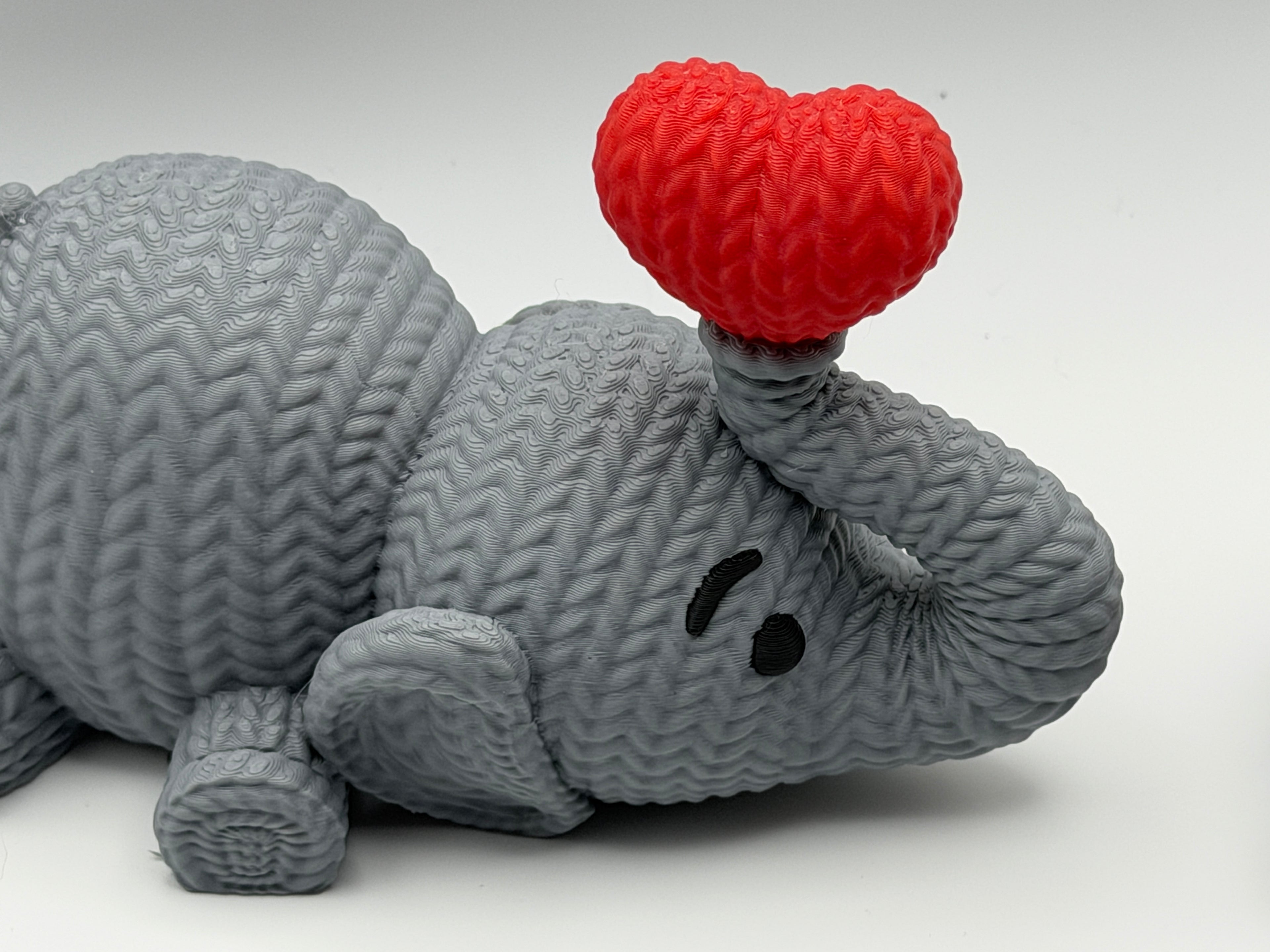 Cute Knitted effect Valentines Elephant lying down with heart on end of trunk