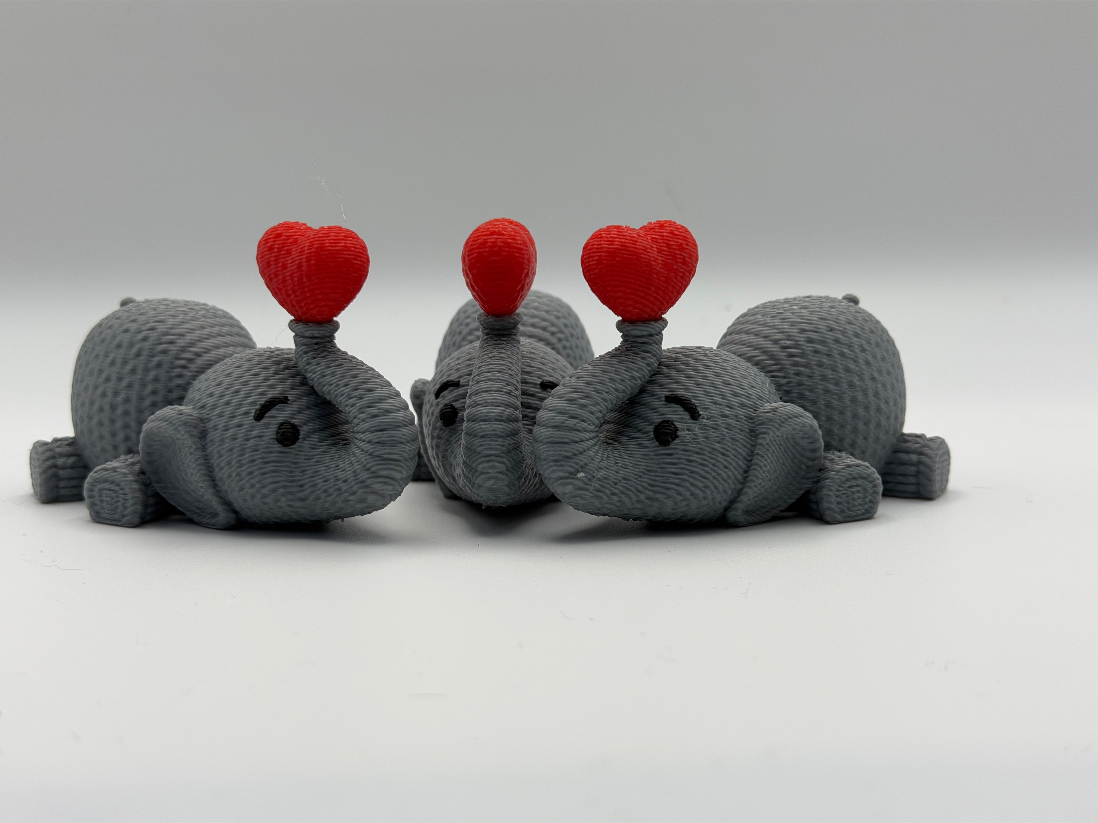 Cute Knitted effect Valentines Elephant lying down with heart on end of trunk